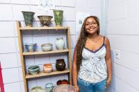 Leelyn Thompson next to her ceramic work.