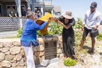 Barbara Eastman and Amber Henry unveil the new plaque at the Dragonfly House for the African American Heritage Trail.