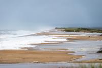 Strong surf drives erosion on the shore.