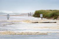 Heavy surf floods onto beach.
