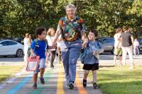 West Tisbury teacher Kate walking two youngsters to class.