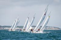 Group of teams approach the marker in tight formation.