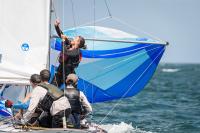 Sailors aboard Robin getting the spinnaker up.