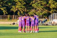 The boys varsity team huddles up before their game.