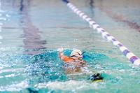 Swimmers practice with and without fins.