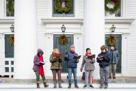 Carolers grace the steps of The Old Whaling Church.
