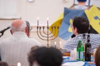 Islanders gather at the MV Hebrew Center to celebrate the first night of Hannukah.